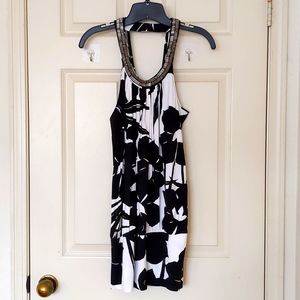 NWT. Express Rayon Black/White Floral Long top with sparkling neck decorations.